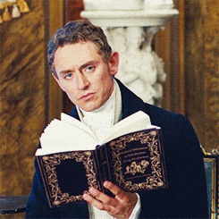A gif of a movie character hiding behind a book